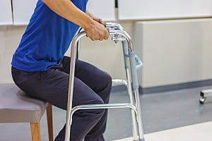 a man using a walker provided by a durable medical equipment supplier